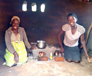 Joyce and Chimwemwe sat using their cookstove